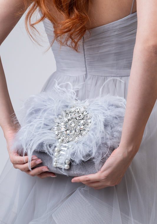 Grey luxury handbag with gemstones and feathers